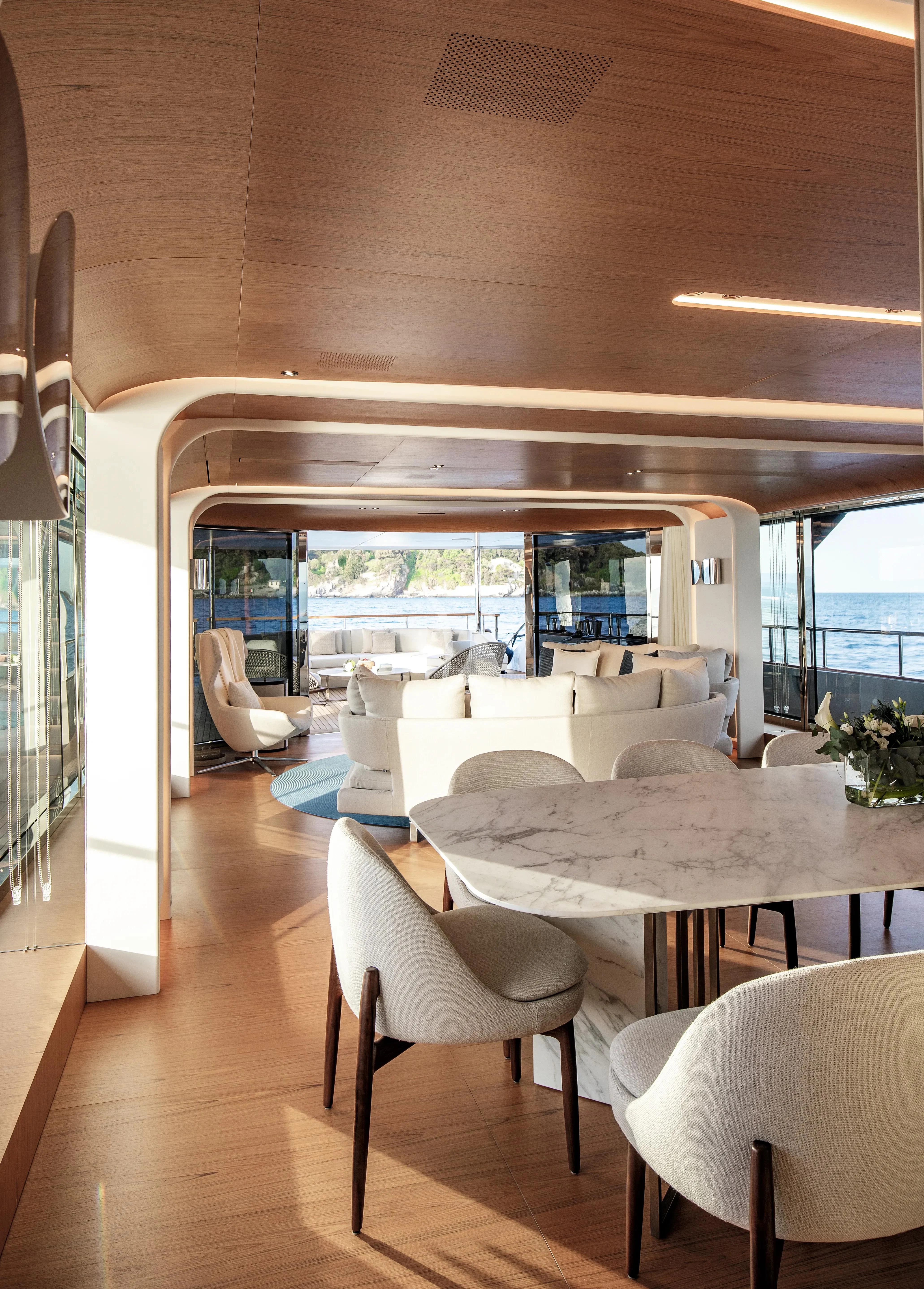 a room with a table and chairs aboard LEGEND Yacht for Sale