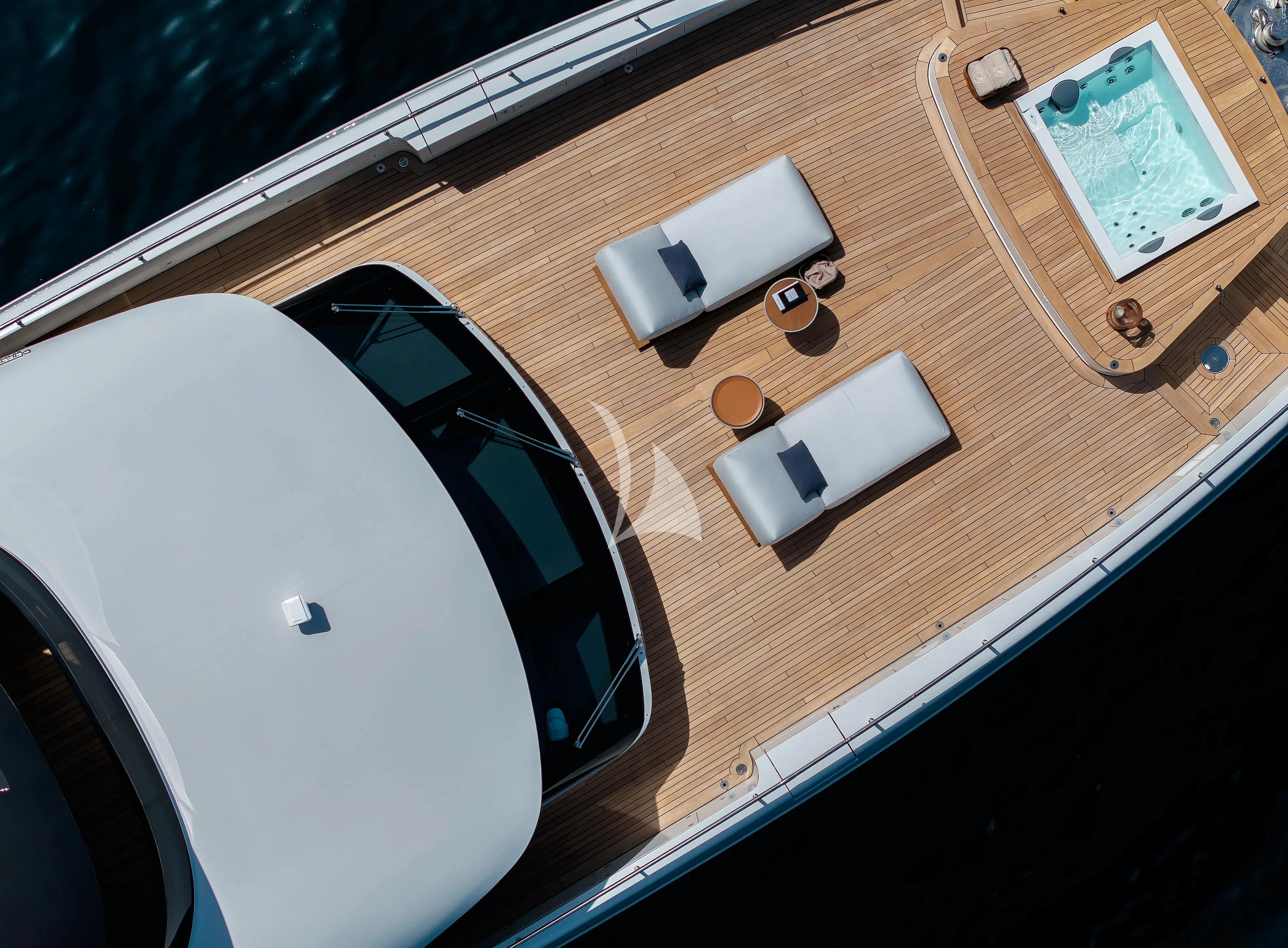 a white computer mouse and a black laptop on a wooden surface aboard LEGEND Yacht for Sale