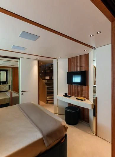 a bedroom with a bed and a tv aboard LEGEND Yacht for Sale