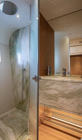 a bathroom with a glass shower aboard LEGEND Yacht for Sale