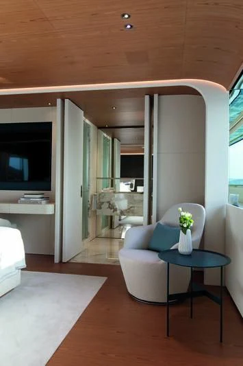 a living room with a blue couch aboard LEGEND Yacht for Sale