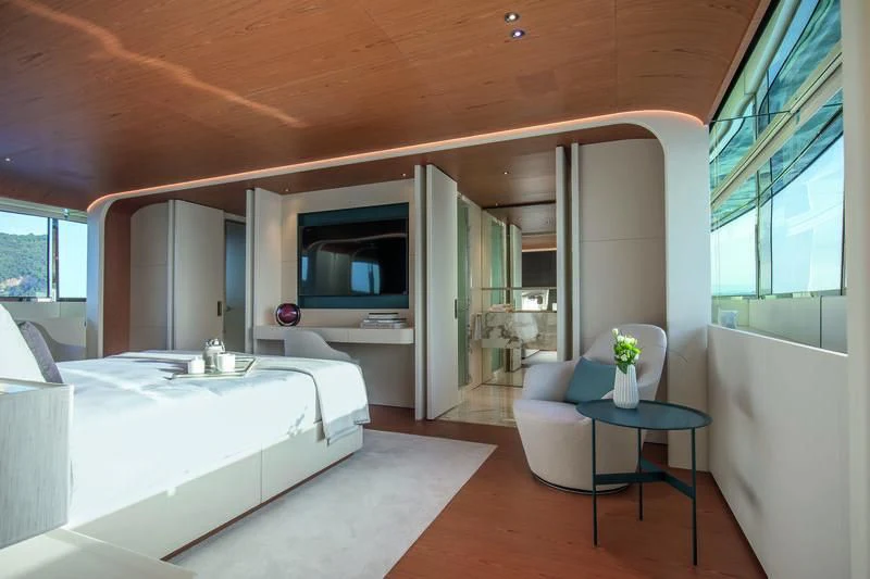 a room with a bed and a table aboard LEGEND Yacht for Sale