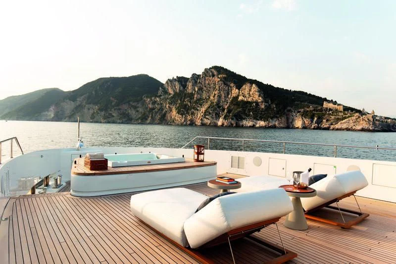 a boat on a deck overlooking a large body of water aboard LEGEND Yacht for Sale