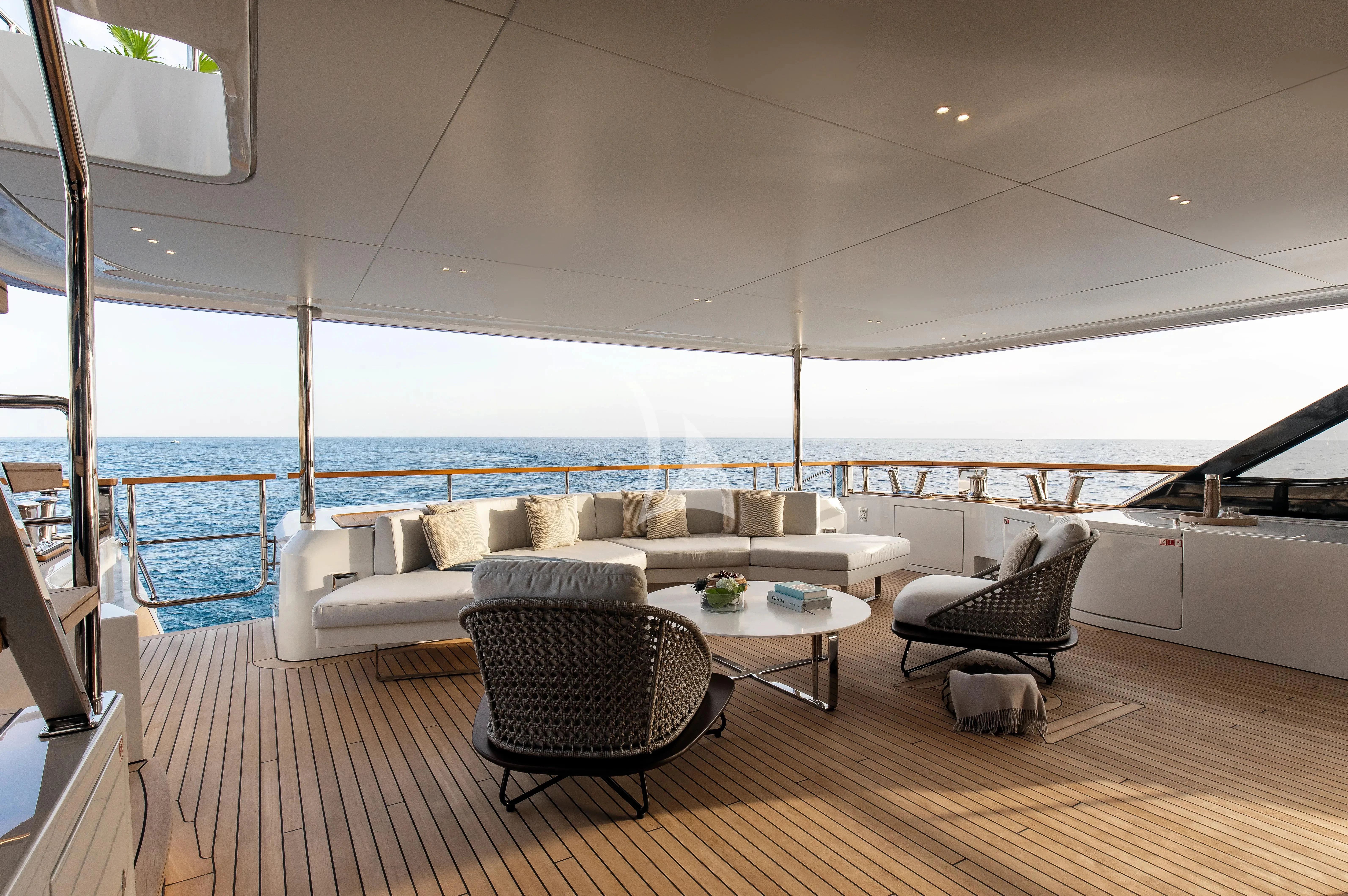 a living room with a large balcony aboard LEGEND Yacht for Sale