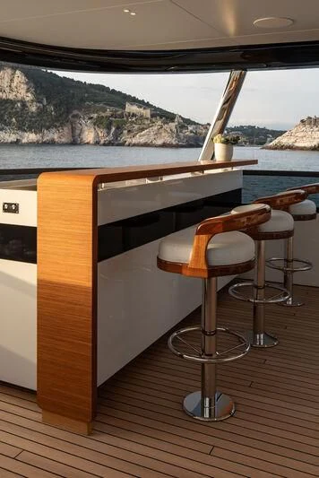 a table and chairs on a deck aboard LEGEND Yacht for Sale