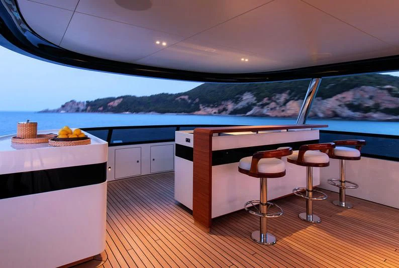 a kitchen with a view of the ocean and mountains aboard LEGEND Yacht for Sale