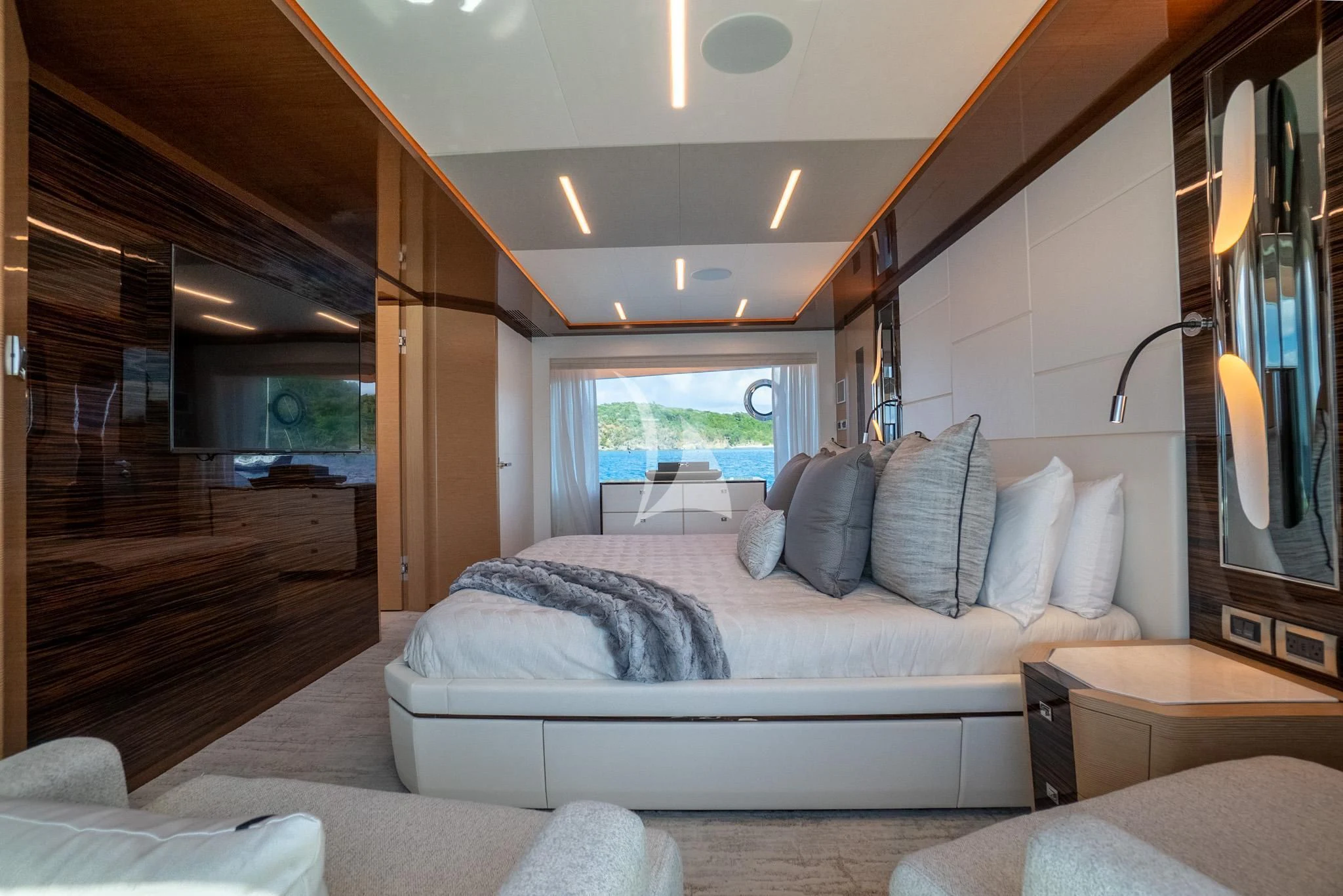 a bedroom with a bed and a large window aboard CHILLAXIN' Yacht for Sale