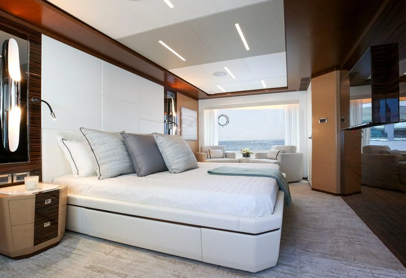 a bedroom with a bed and a desk aboard CHILLAXIN' Yacht for Sale