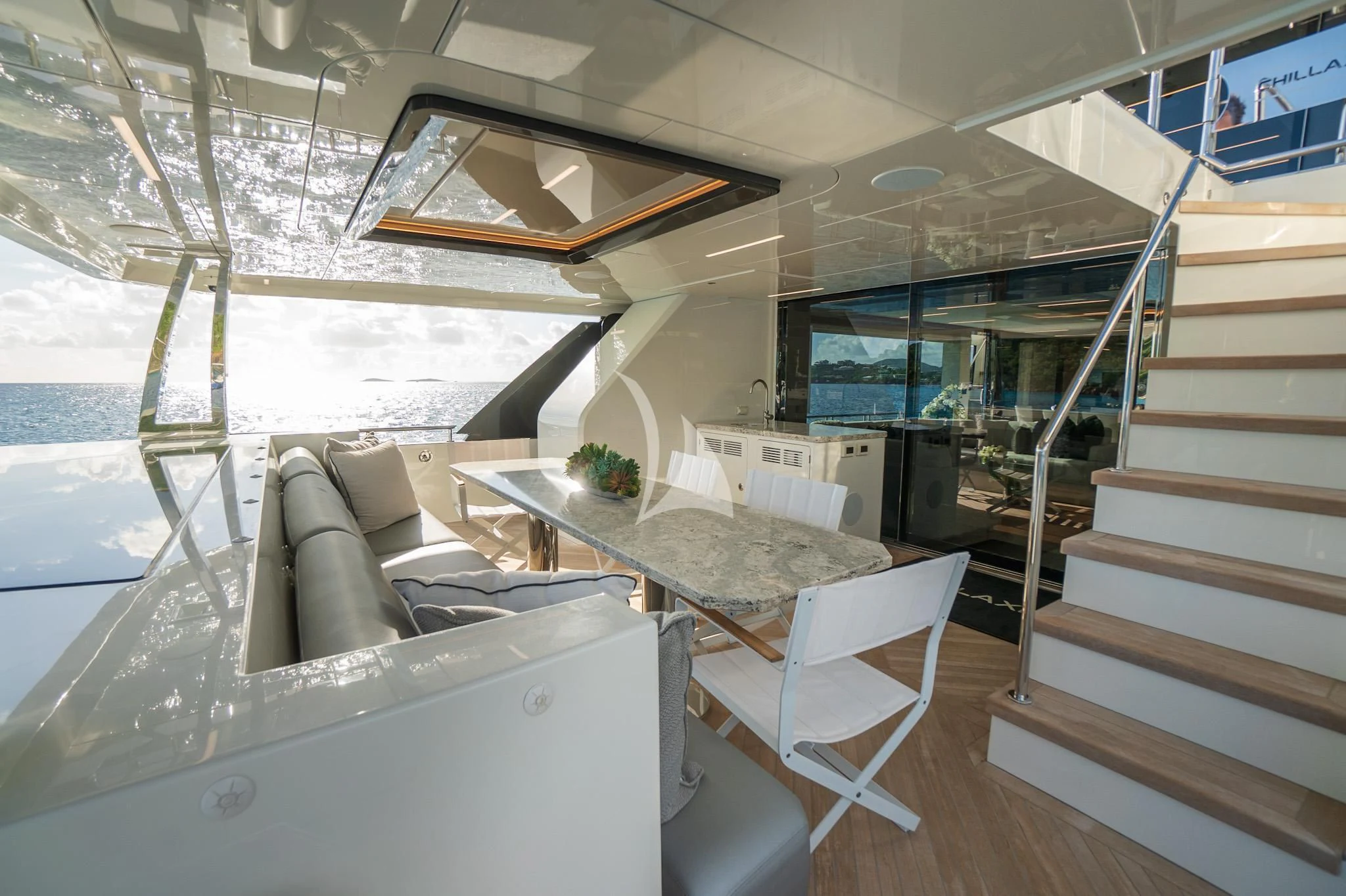 a room with a staircase and furniture aboard CHILLAXIN' Yacht for Sale