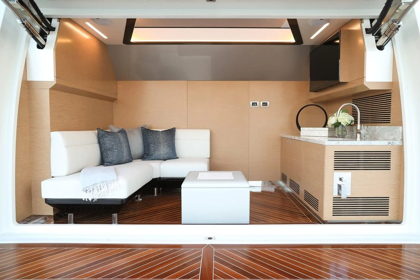 a living room with a couch and a sink aboard CHILLAXIN' Yacht for Sale