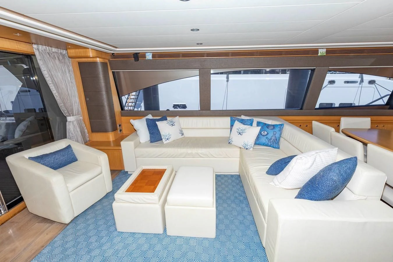 a room with a couch and a table and chairs aboard MI RX Yacht for Sale