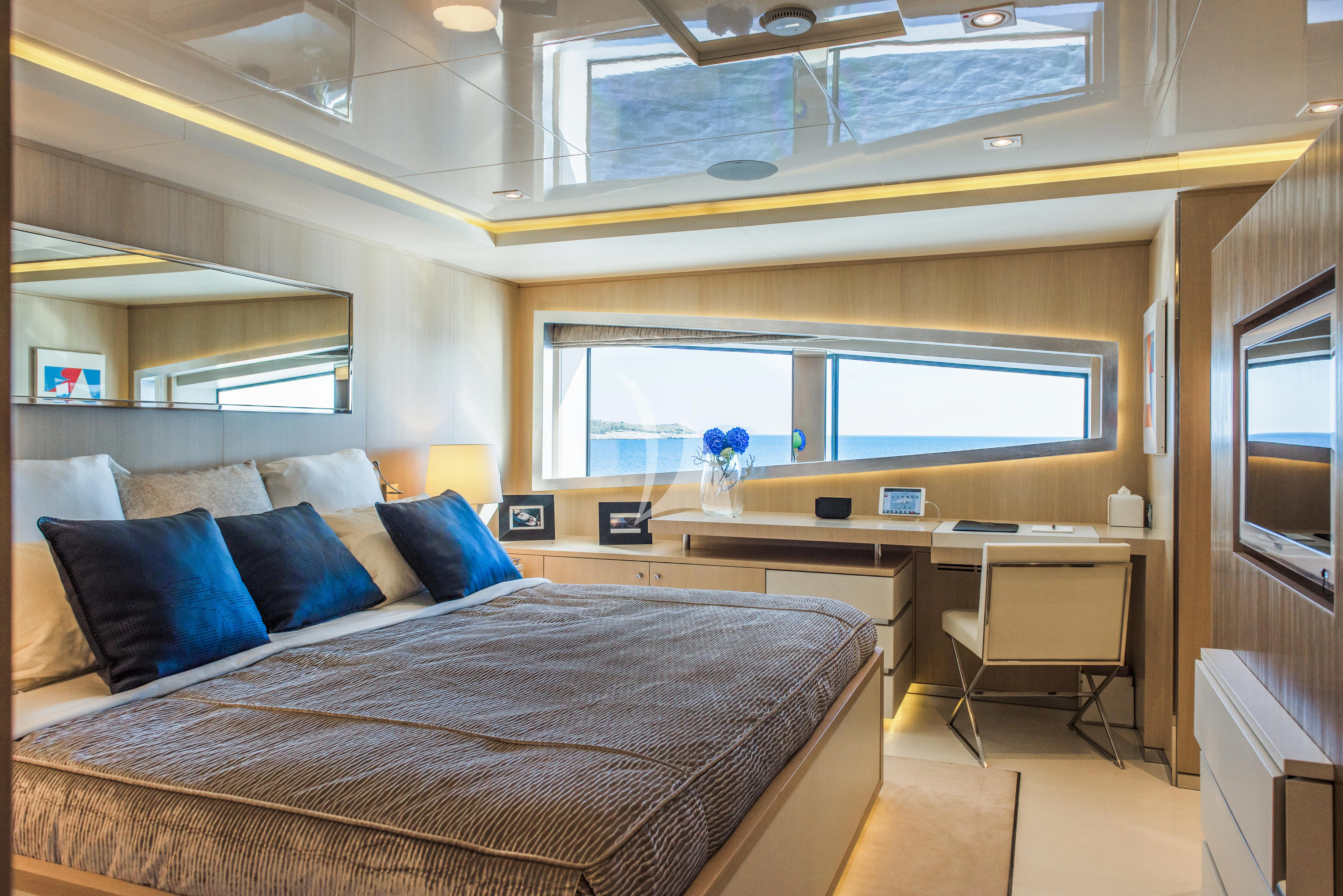 a bedroom with a bed and desk aboard ELENI Yacht for Sale