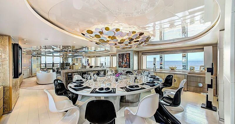 a large room with a table and chairs aboard ELENI Yacht for Sale