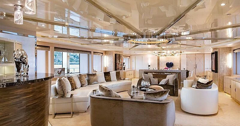 a living room with a large chandelier aboard ELENI Yacht for Sale