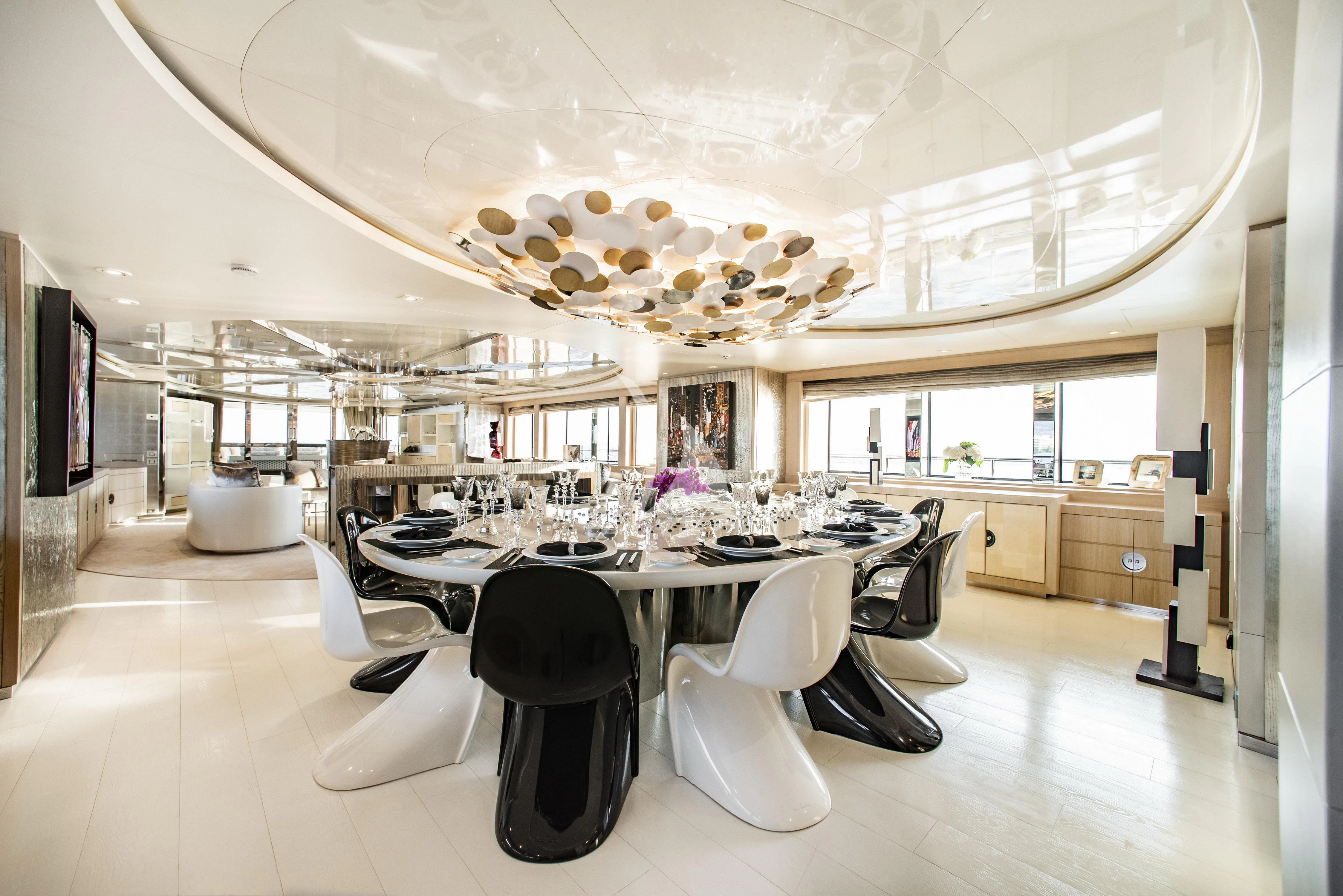 a large room with a table and chairs aboard ELENI Yacht for Sale