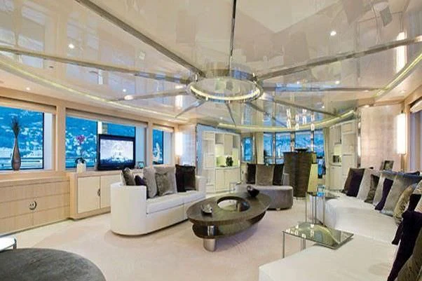 a room with a large white couch and a large chandelier aboard ELENI Yacht for Sale
