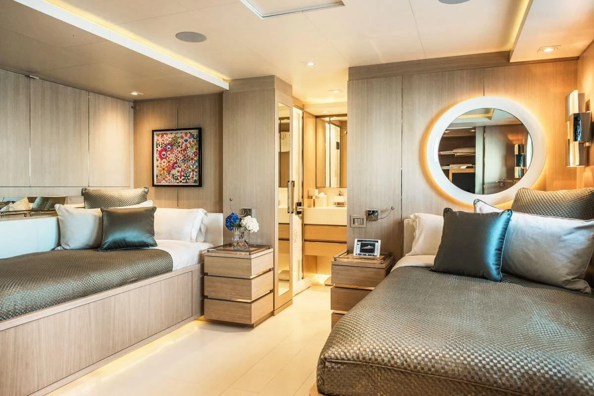 a bedroom with a bed and a mirror aboard ELENI Yacht for Sale