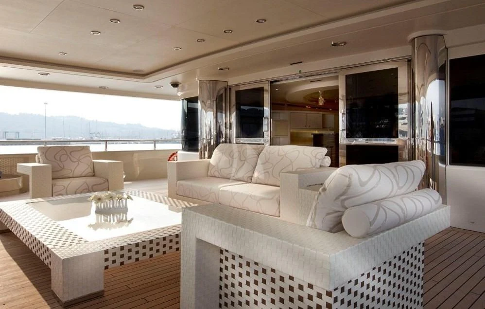 a living room with a large white couch and a large window aboard ELENI Yacht for Sale