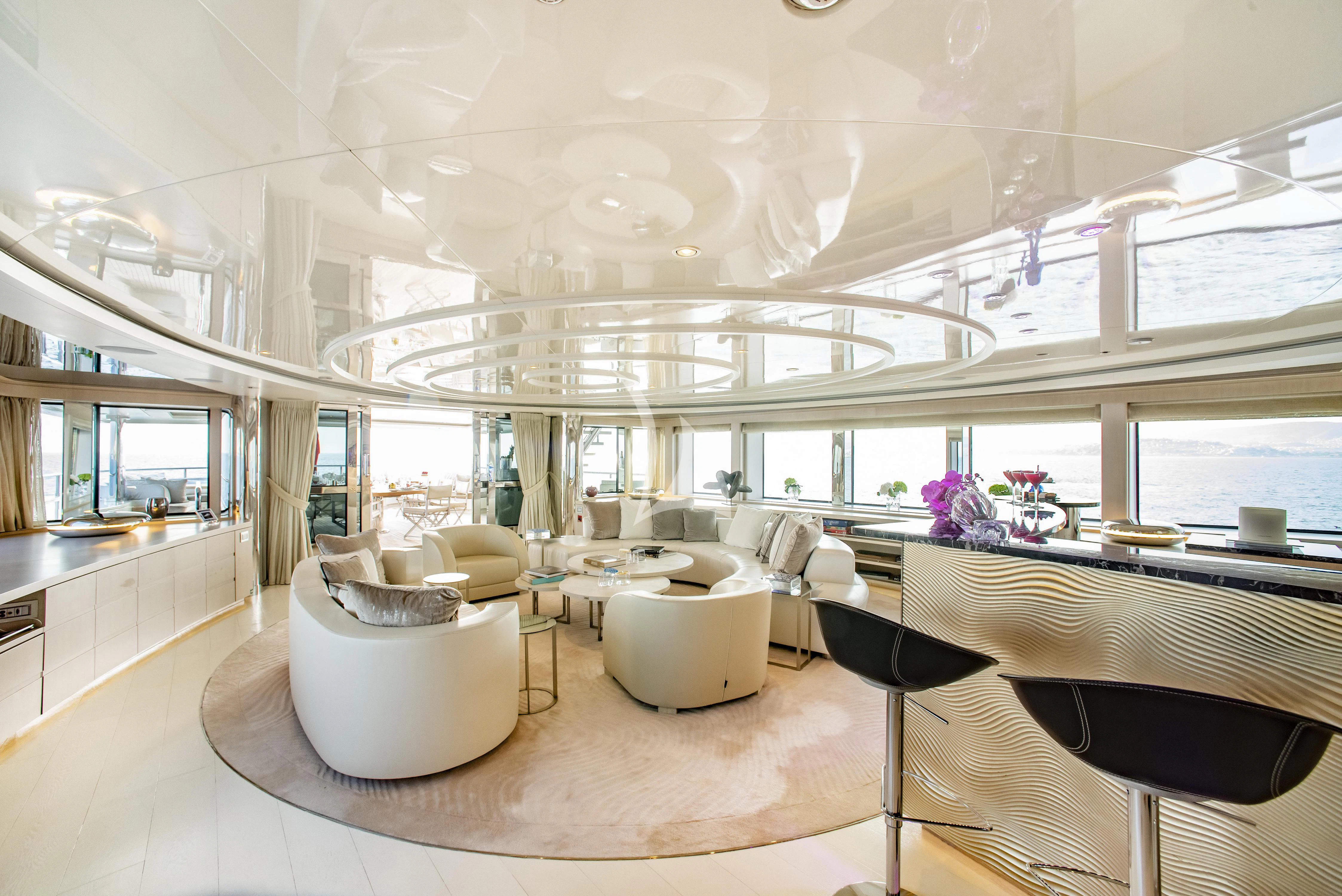 a room with tables and chairs aboard ELENI Yacht for Sale