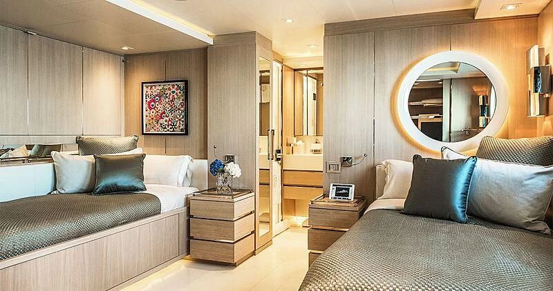 a bedroom with a bed and a large mirror aboard ELENI Yacht for Sale