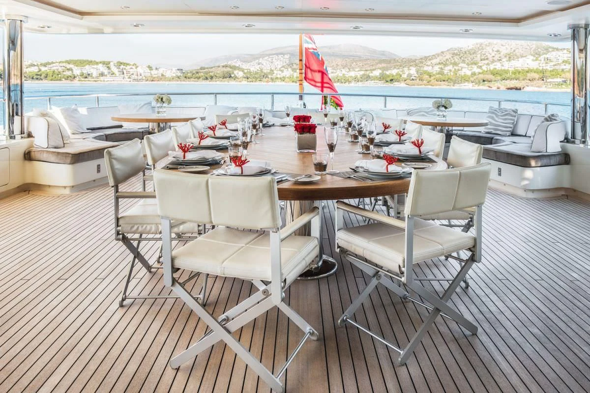 a table and chairs on a deck aboard ELENI Yacht for Sale