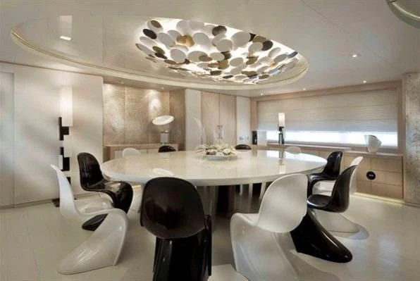a room with a table and chairs aboard ELENI Yacht for Sale