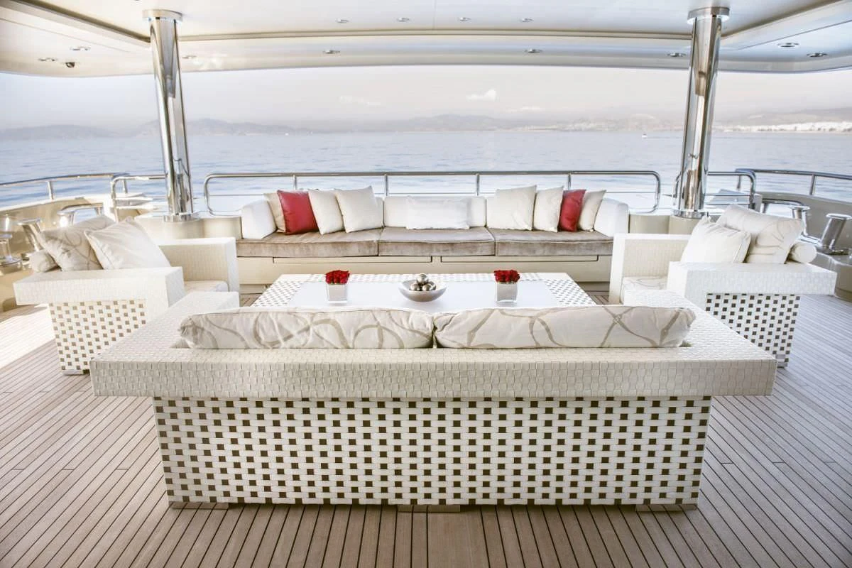 a room with a bed and chairs aboard ELENI Yacht for Sale
