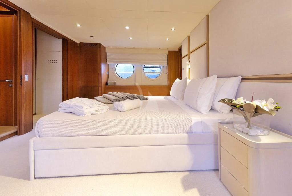 a bedroom with a bed and a desk aboard FUNSEA Yacht for Sale