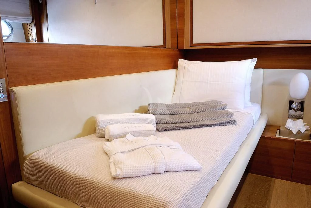a bed with white pillows aboard FUNSEA Yacht for Sale