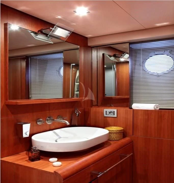 a bathroom with a sink and a mirror aboard FUNSEA Yacht for Sale