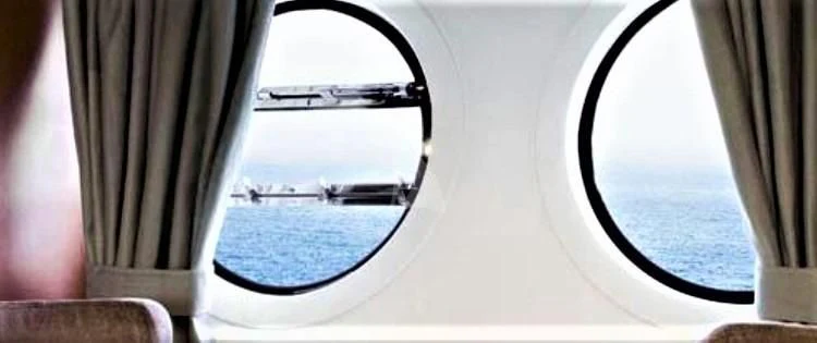 a window with a view of the water and the city below aboard FUNSEA Yacht for Sale