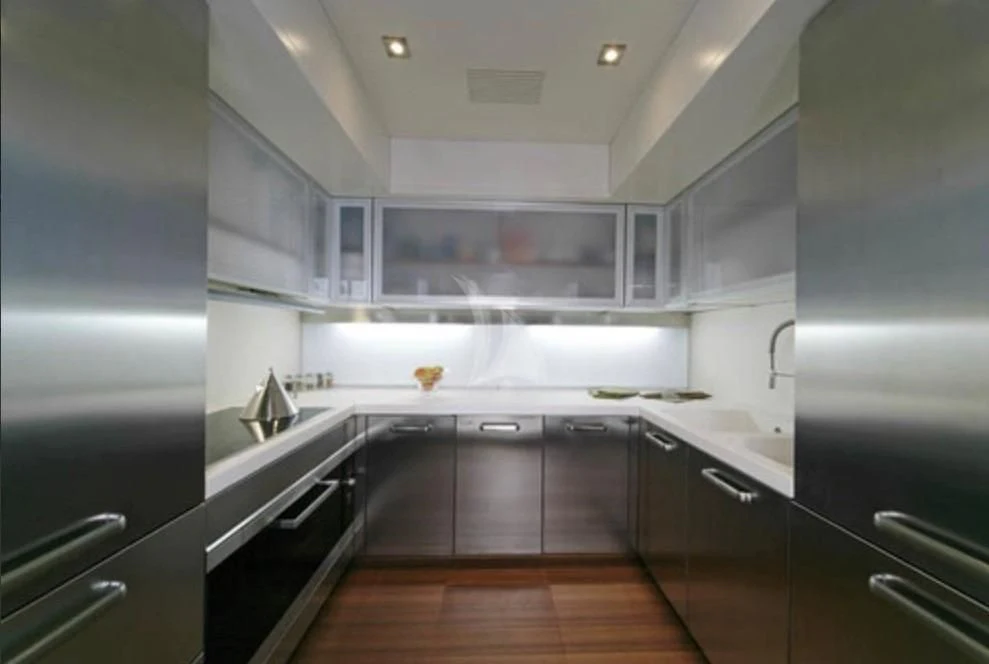 a kitchen with black cabinets aboard FUNSEA Yacht for Sale