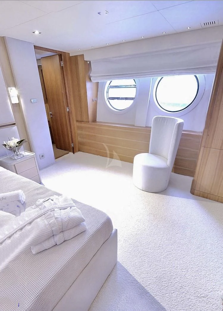 a room with a bed and a chair aboard FUNSEA Yacht for Sale