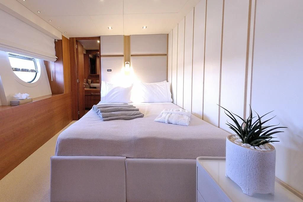 a bed with a plant on the side aboard FUNSEA Yacht for Sale