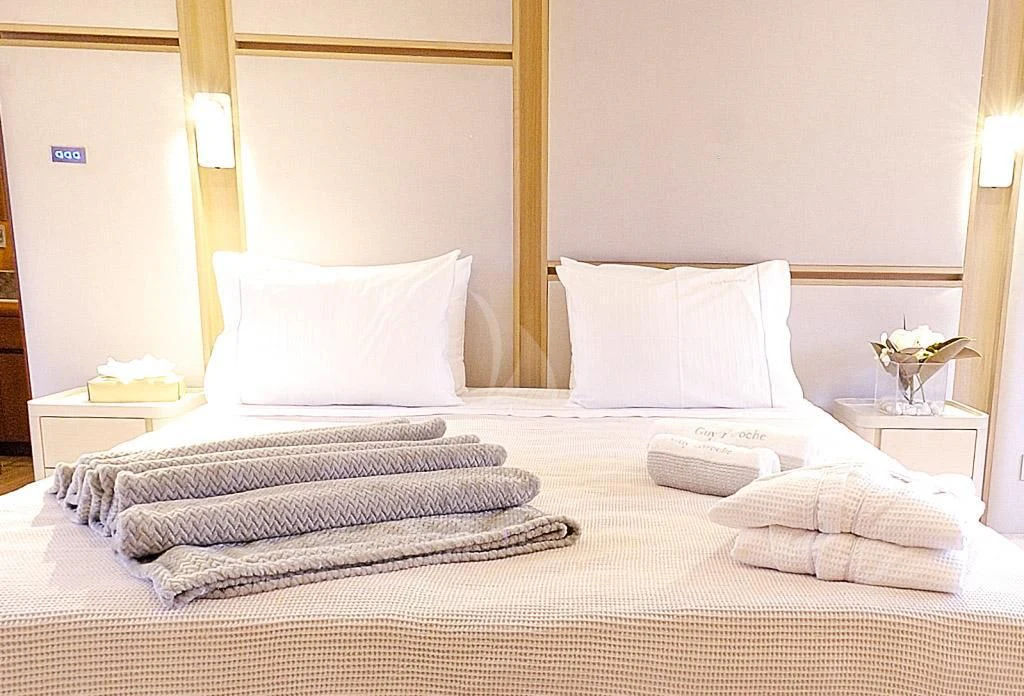 a bed with white pillows aboard FUNSEA Yacht for Sale