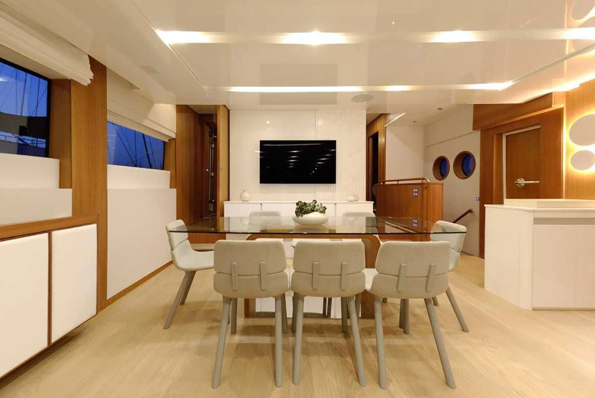 a large kitchen with a table and chairs aboard FUNSEA Yacht for Sale