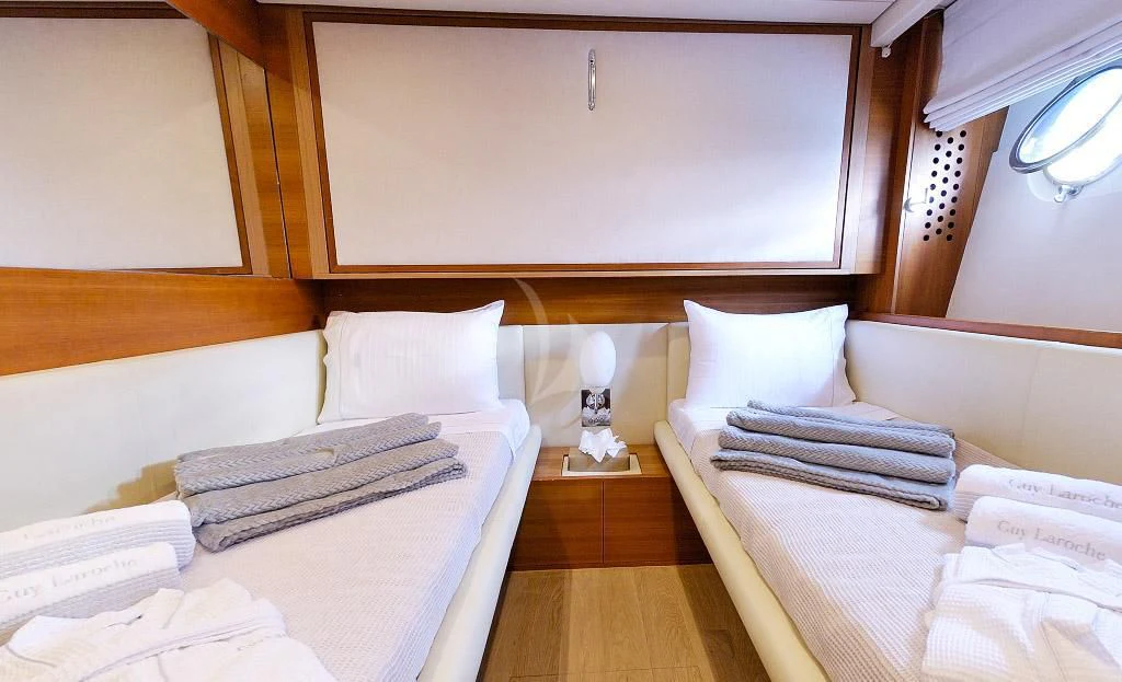 a room with beds and a wood cabinet aboard FUNSEA Yacht for Sale