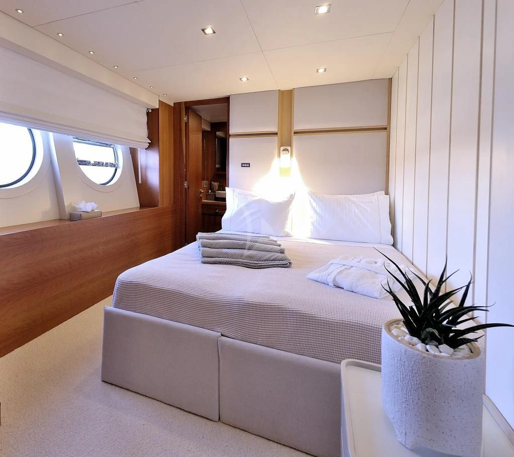 a bed with a plant on the side aboard FUNSEA Yacht for Sale