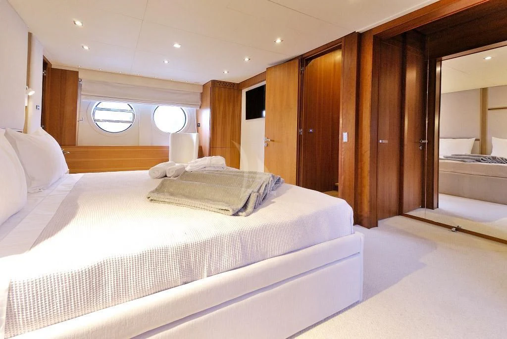 a room with a bed and a mirror aboard FUNSEA Yacht for Sale