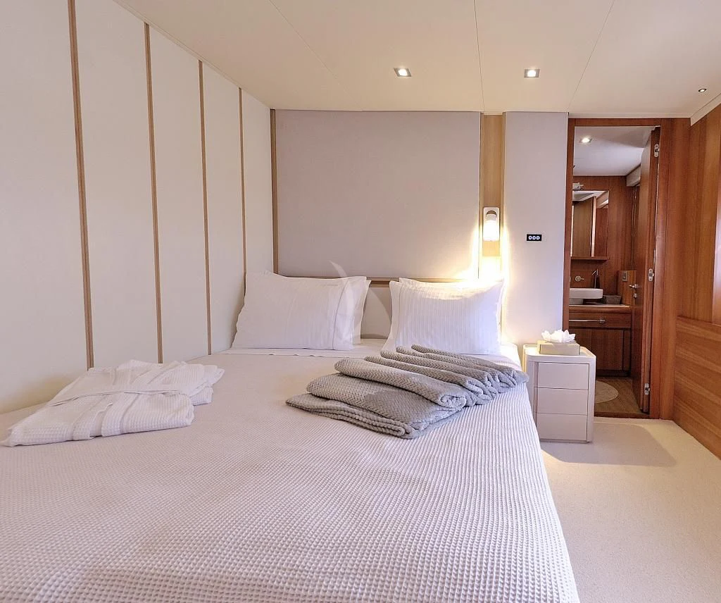 a bed with white sheets aboard FUNSEA Yacht for Sale