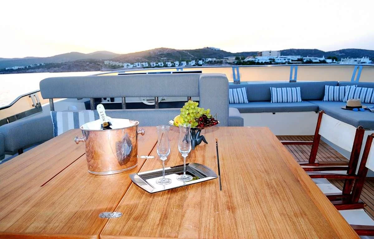 a table with a glass vase and a candle on it aboard FUNSEA Yacht for Sale