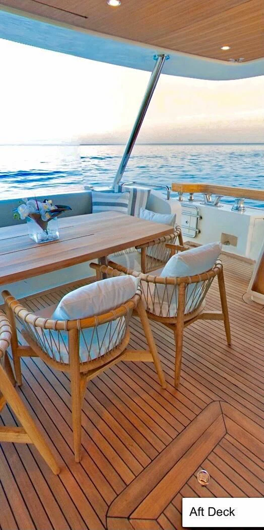 a table and chairs on a deck aboard FUNSEA Yacht for Sale