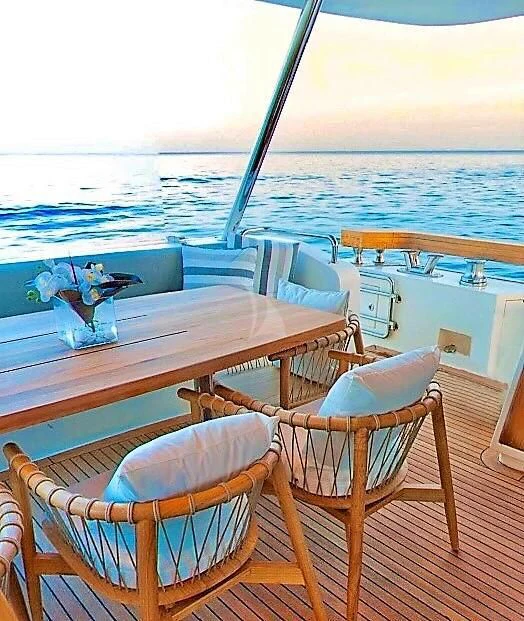 a table and chairs on a deck aboard FUNSEA Yacht for Sale