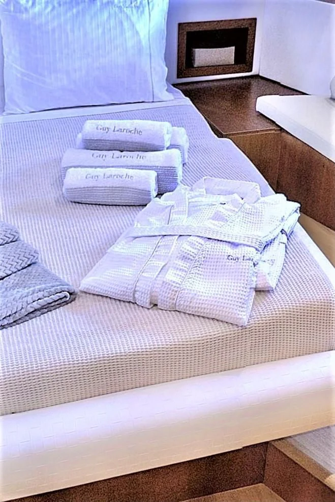 a bed with folded towels aboard FUNSEA Yacht for Sale