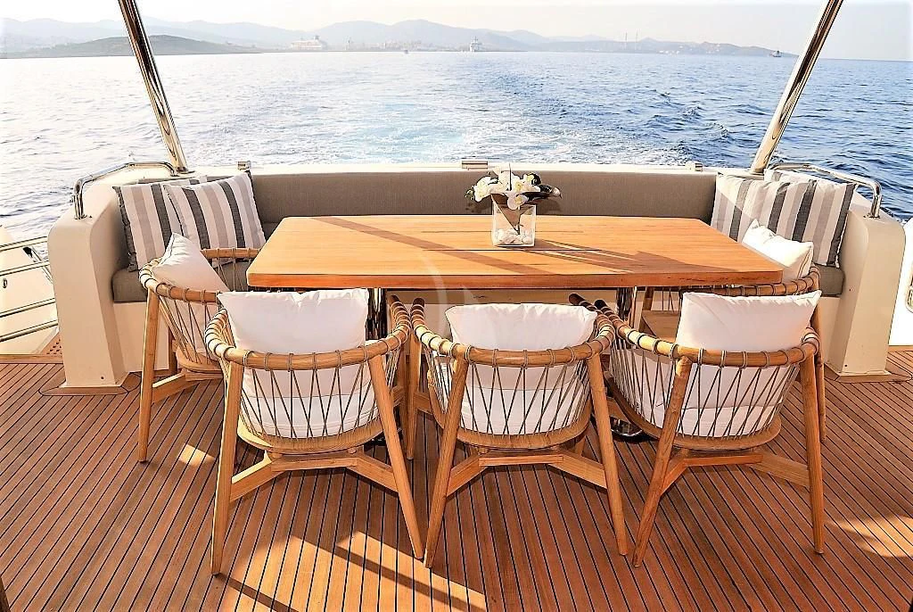 a table set for a meal on a deck overlooking the ocean aboard FUNSEA Yacht for Sale