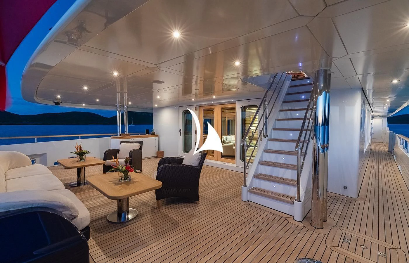 a room with a staircase and furniture aboard ODESSA Yacht for Charter
