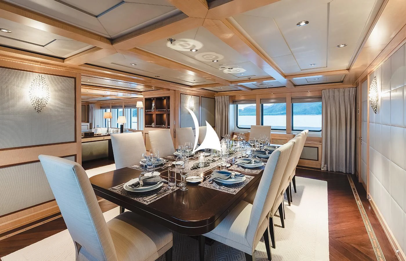 a large dining table in a room aboard ODESSA Yacht for Charter