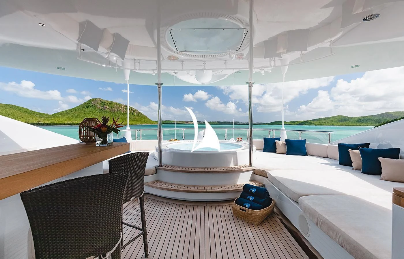 a room with a table chairs and a view of the water aboard ODESSA Yacht for Charter