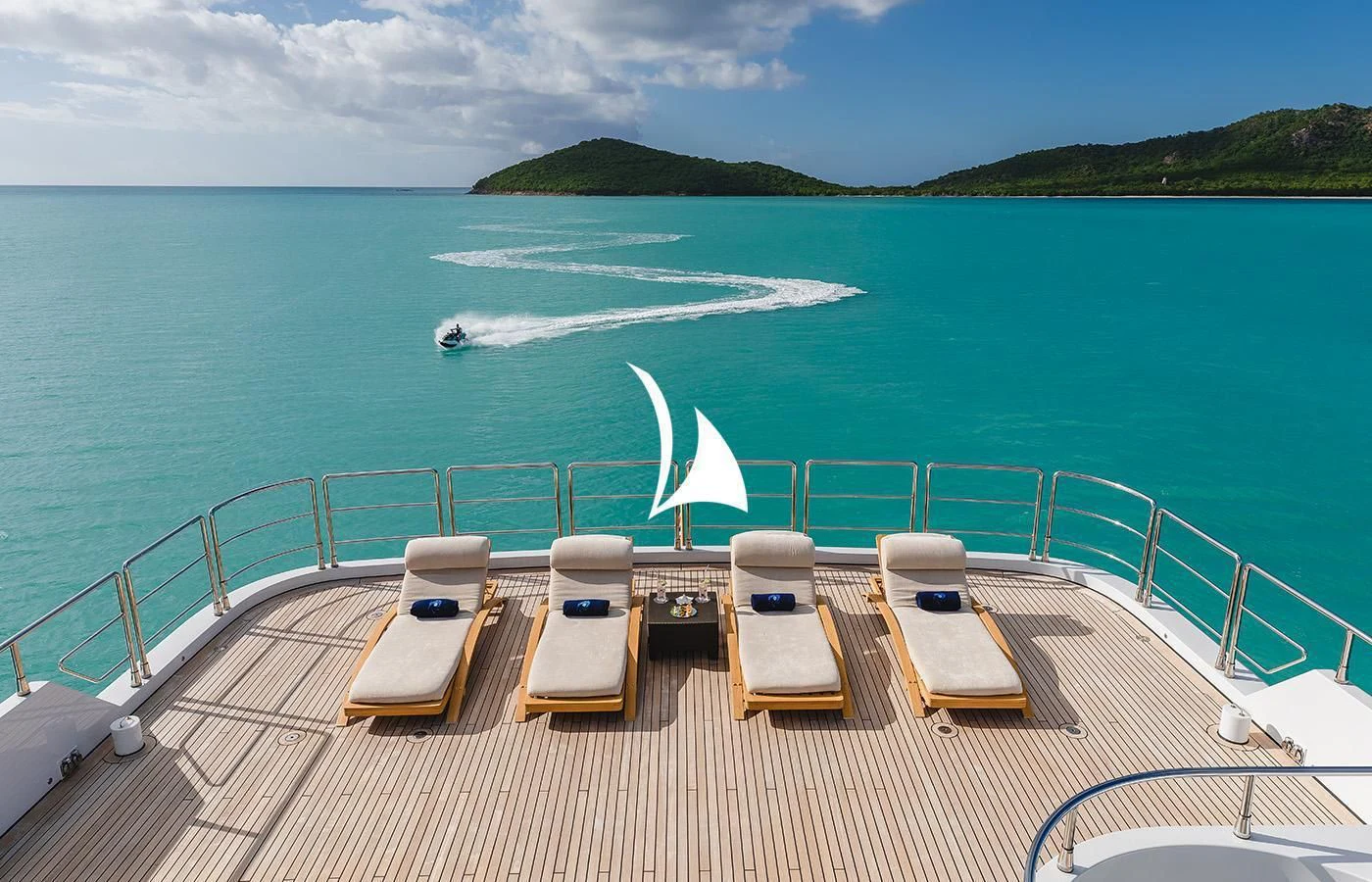 chairs on a deck overlooking a beach aboard ODESSA Yacht for Charter