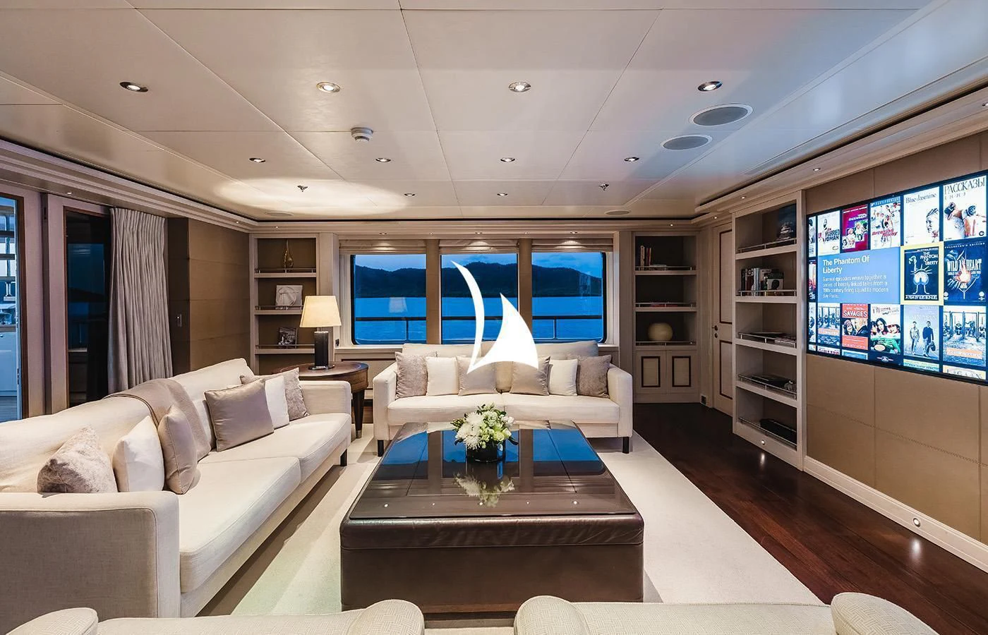 a living room with a large window aboard ODESSA Yacht for Charter